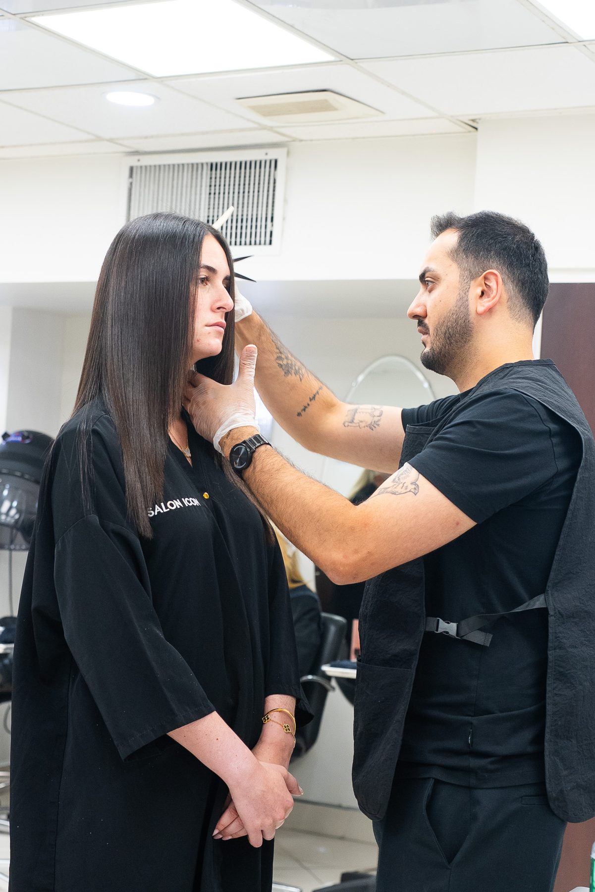 Stylist consulting with a client before a precision cut at Salon Icon NYC